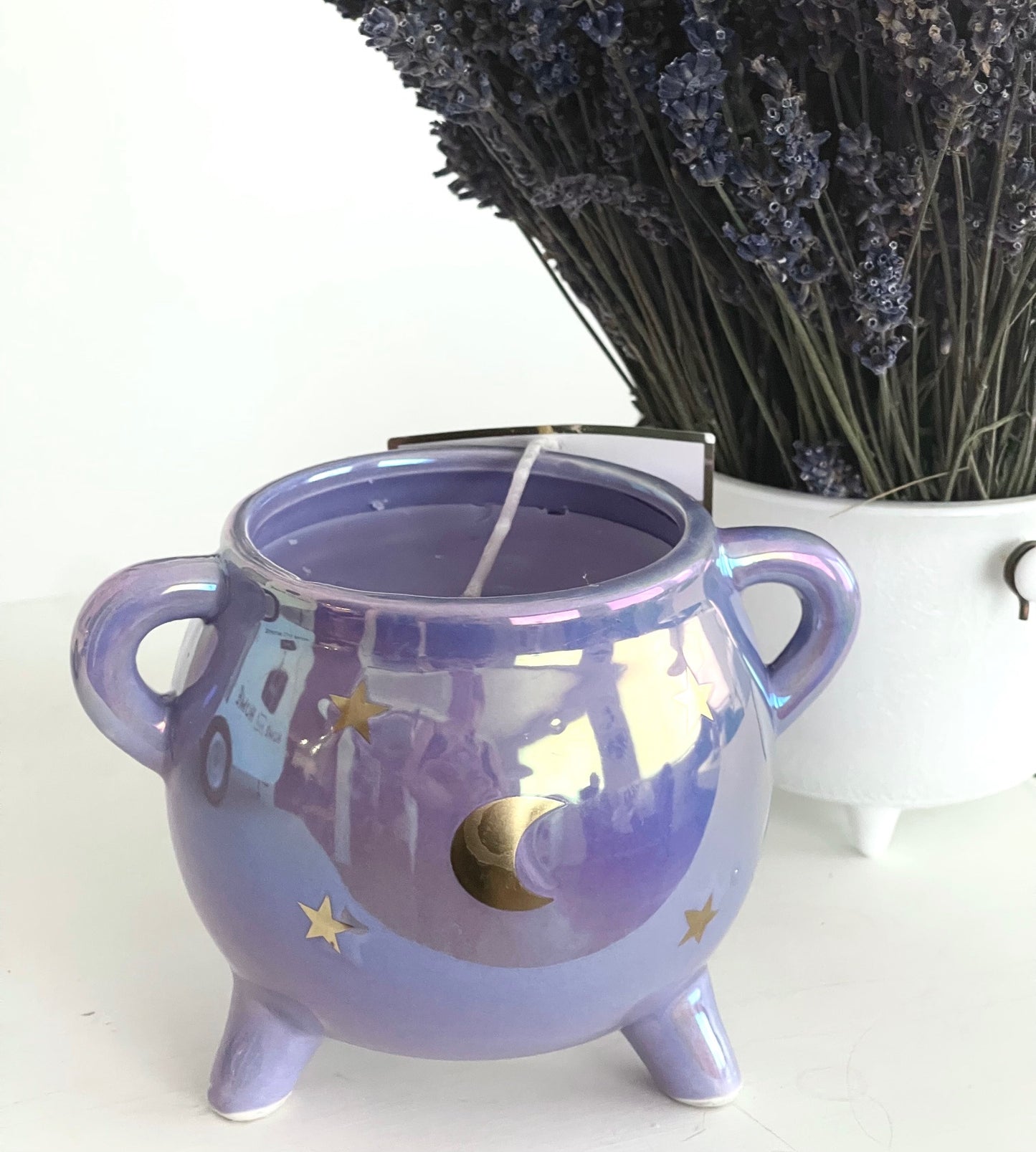 lifestyle view of candle with lavender bouquet