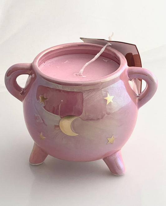 pink cauldron candle with moon and stars